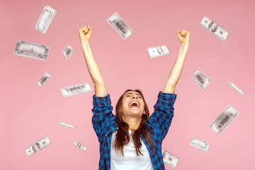 Money rain, winner and rich. Hurray. satisfied happy young woman rising hands up with toothy smile...
