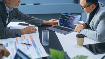 Multi-Ethnic Office Conference Room Businesspeople Meeting at Big Table. Diverse Team of Creative Entrepreneurs Talk, Find Solution. Specialists work in Digital e-Commerce Startup. Focus on Hands