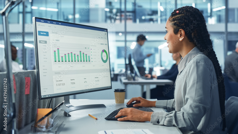 Poster Corporate Office: Black Female IT Technician Using Desktop Computer with Big Data Statistics, Graphs. Smiling Creative Software Engineer Work on eCommerce Project Marketing, Development.