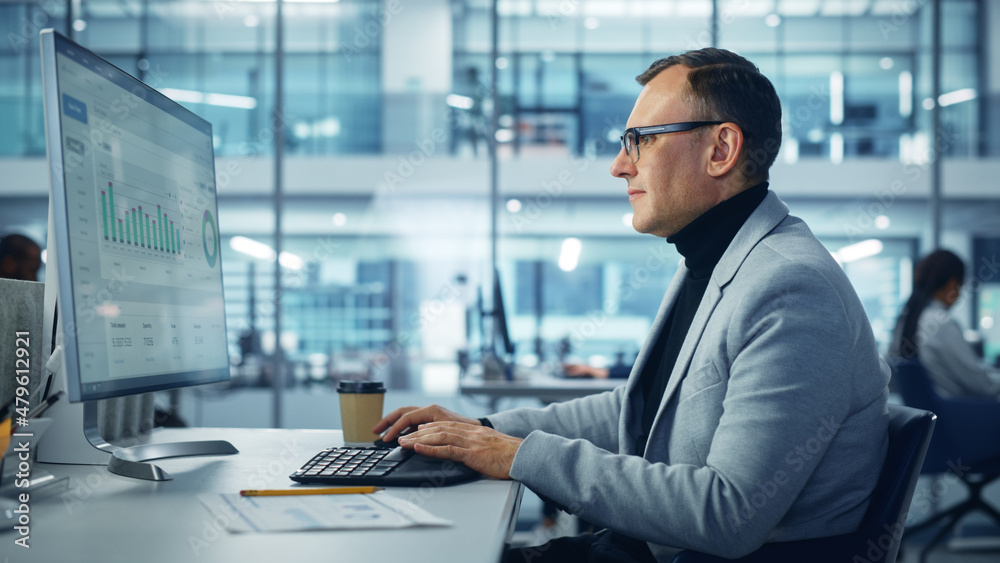 Poster Diverse Corporate Office: Stylish Handsome Big Data Engineer Using Desktop Computer, Screen Showing Graphs, Statistics, Company Growth. Businessman Working on e-Commerce Project Marketing, Development