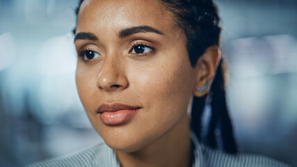 Portrait of Gorgeous Black Woman with Deep Brown Eyes, Braided Hair, Perfect Smile. Beautiful Girl Turn. Bokeh out of Focus Background. Close-up