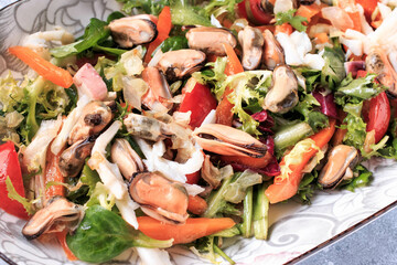 Homemade Seafood Salad mixed with fresh vegetable. Healthy food, sea food. Gray background. Top view.