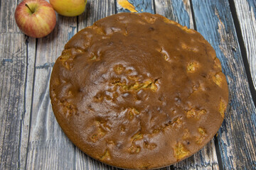 Delicious cake with shredded apples on a rustic wooden table