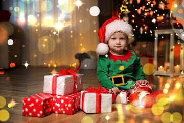 Fototapeta na wymiar Baby wearing cute Christmas costume with gifts at home
