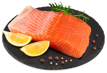 Red fish. Raw salmon fillet with rosemary, peppercorns and lemon on black round stone plate isolate on white background. Clipping path and full depth of field