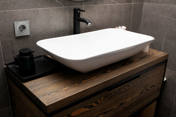 Modern bathroom with wooden table under the sink