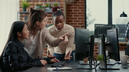 Mixed team of programmers brainstorming ideas for new code library in front of computer screens compiling algorithms. Cyber security app developers collaborating on group project in it agency office. - Powered by Adobe