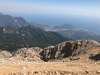 Beautiful landscape view from a high mountain to the forest and mountains in a tropical country with resorts and the sea