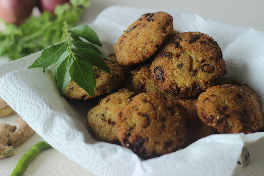 Kodo millet fritters. A crispy fritters made with cooked and mashed kodo millet flour and spices. Disk shaped deep fried evening snack. Commonly known as Kodo millet vada
