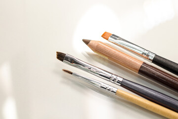 Obraz premium Makeup brushes and pencil for eyebrows. Artistic brushes close-up. Beautiful makeup brushes. 