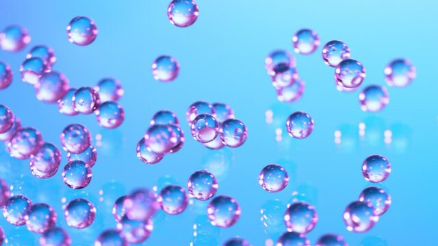 Super Slow motion Shot of Neon Hydrogel Balls Bouncing on Glass at 1000fps.