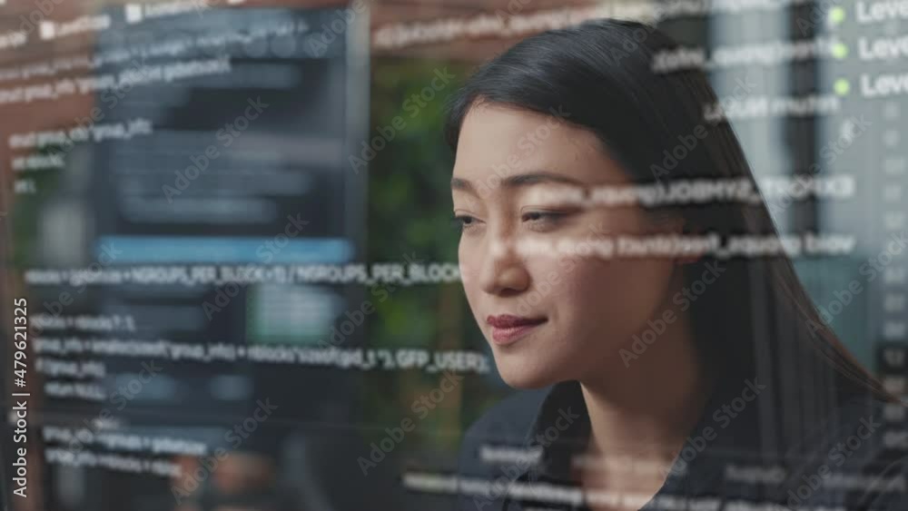 Fototapete Portrait of focused asian software developer through vfx of floating programming code writing and smiling sitting at desk. App developer looking at hologram of machine learning data algorithm.