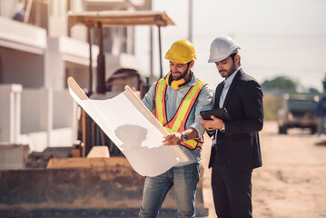 Civil engineer and construction worker manager holding digital tablet and blueprints , talking and...