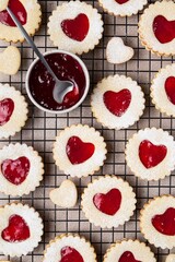 Linzer cookies in shape of heart with jam on light background. Mother's day, Women's day, Valentine's day. Homemade present.