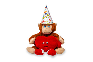 A soft toy monkey made of faux fur hugs a smiling fabric heart. Isolated children's toy on a white background. Composition of toys for Valentine's Day.