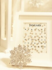 Calendar January 2022 in a frame, interior decor, snowflakes, stars, white and pastel tone background. 