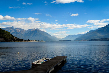 Panorama of lake Como in Italy with mountains in background an beautiful blue sky with small clouds
