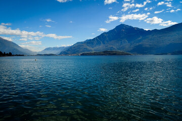 panorama of lake como with monte Legnone in background, blue water an beautiful bluee sky