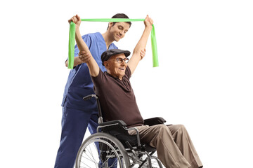 Obraz premium Physical therapist helping an elderly man in a wheelchair exercising with a stretch band