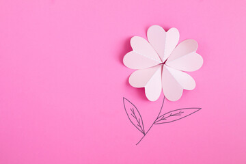 Creative flowers composition. Pink paper heart shape flower on the pink background. Copy space.