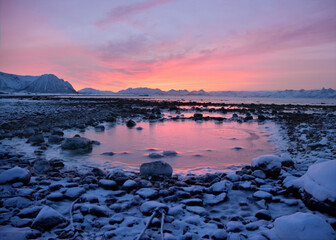 Fototapeta na wymiar Sunset over frozen beach in Norway
