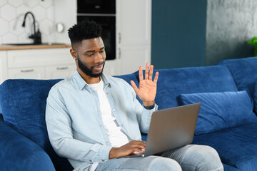 African American Man working from home with laptop and phone