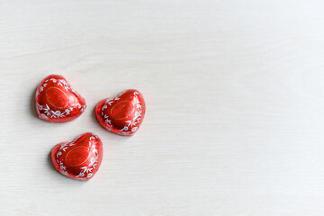 Three chocolate candy heart closeup