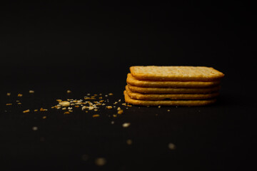 Cracker cookies with crumbs lies on the background