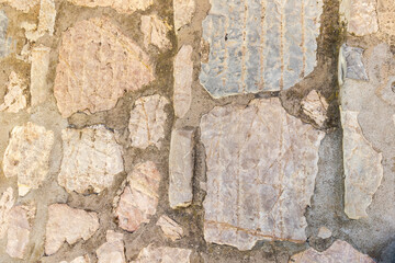 Pattern of quarry stones used as pavement in the island capital Portoferraio on the island of Elba in Italy under a bright blue sky in summer