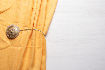 Yellow curtains on the white flat lay background with copy space.