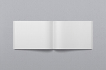 The landscape template of an open book, with flipped pages, with realistic shadows, for presentation of design.