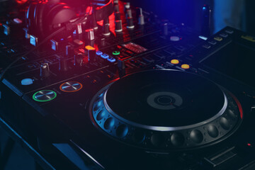 Obraz na płótnie Canvas Closeup view of modern DJ controller with headphones