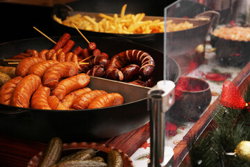 Street food. Grilled sausages at the Christmas market. Fast food. Street food for sale