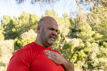 Caucasian middle-aged man has chest pain. Heart attack concept.