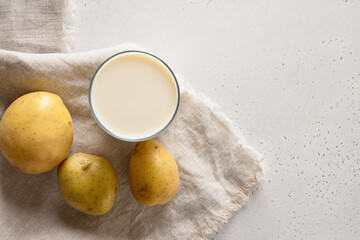 Vegan potato milk on white background. Top view. Copy space. Plant based milk replacer and lactose free.