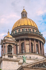 Fototapeta na wymiar bottom view of the gilded dome and colonnade of St. Isaac's Cathedral against the background of the blue sky. Saint Petersburg. Russia