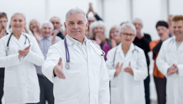 Doctor gives hand in bright modern hospital