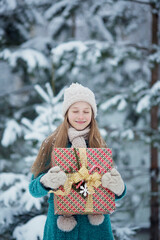 A girl brings gifts to a snowy winter forest. Christmas Eve. selective focus