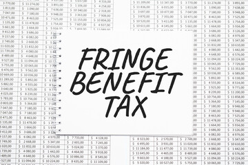 FRINGE BENEFIT TAX text on paper with calculator,magnifier ,pen on the graph backgroundd