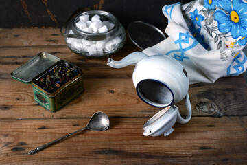 vintage teaware and towel on wooden table