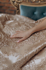 A beautiful girl in an evening dress smile shows a brick wall dress