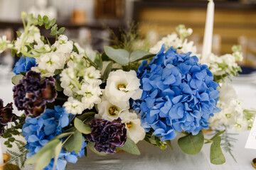 bouquet of flowers on the table in blue colors and hydrangea