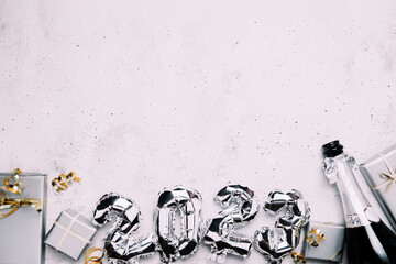 New Year 2023 gray background flat lay. Top view on 2023 balloon silver metallic numbers with grey...