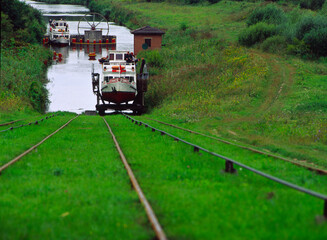 Elblag canal. Elblaski canal. Tourist boat is transported from one lake to another on an oblique plane of the Elblag Canal. The system works with water power. Pochylnia Caluny - obrazy, fototapety, plakaty