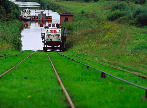 Elblag canal. Elblaski canal. Tourist boat is transported from one lake to another on an oblique plane of the Elblag Canal. The system works with water power. Pochylnia Caluny