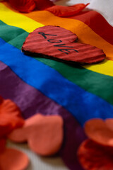closeup of a heart with the word LOVE on an LGBT flag. valentines day celebration homosexual couple