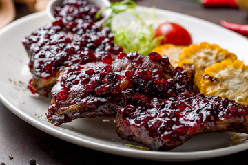 fried pork ribs with lingonberry sauce macro close up