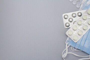 blue masks with pills on gray background