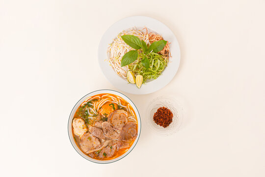 Bun Bo Hue, Vietnamese spicy beef rice noodle soup, Vietnamese food isolated on white background, top view