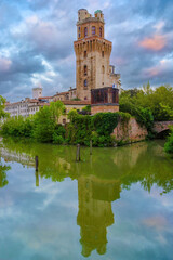 Fototapeta na wymiar Torlonga tower reflected in water. Historical Carrara Castle in Padua, Veneto, Italy